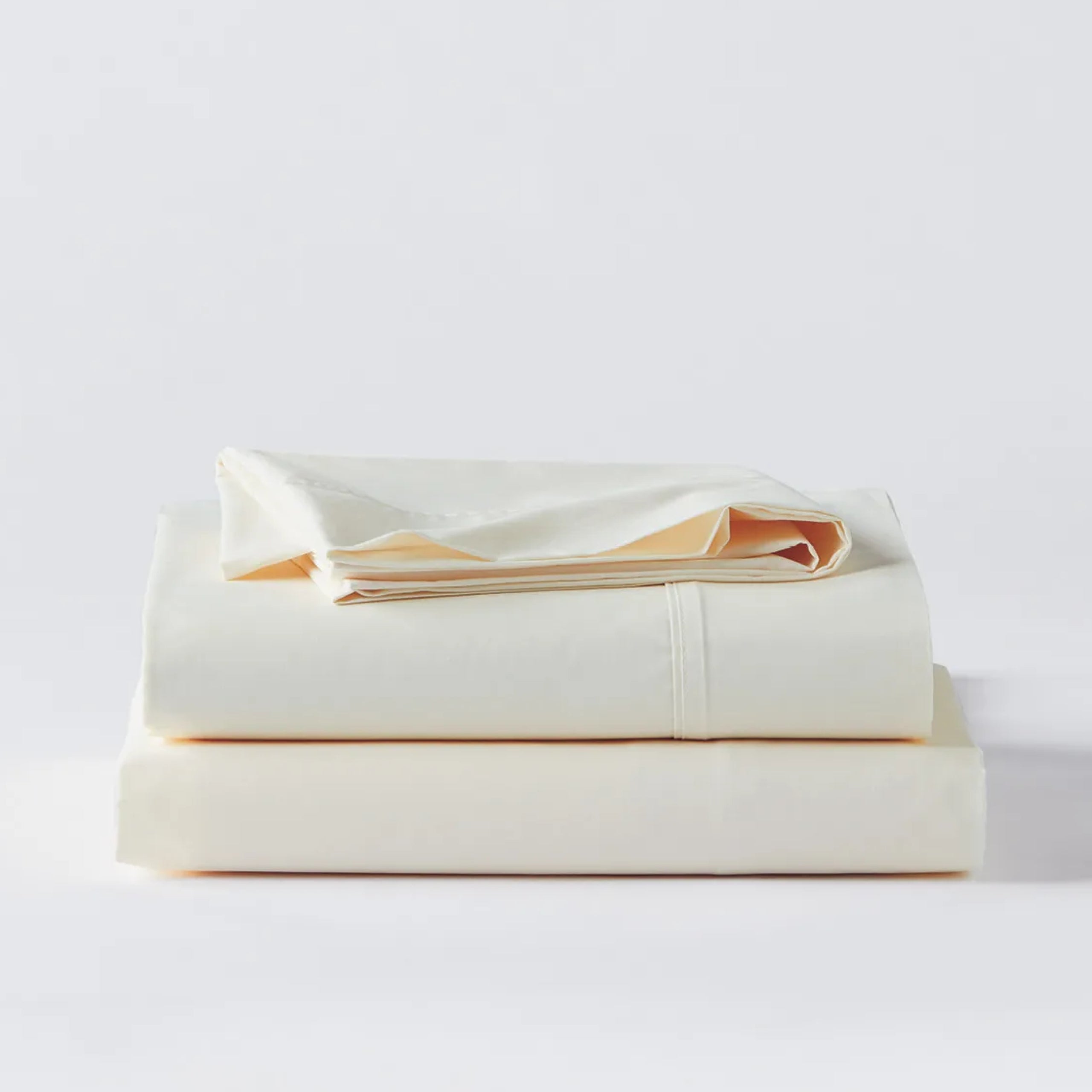 Premium Percale Ecru Sheets folded up on floor