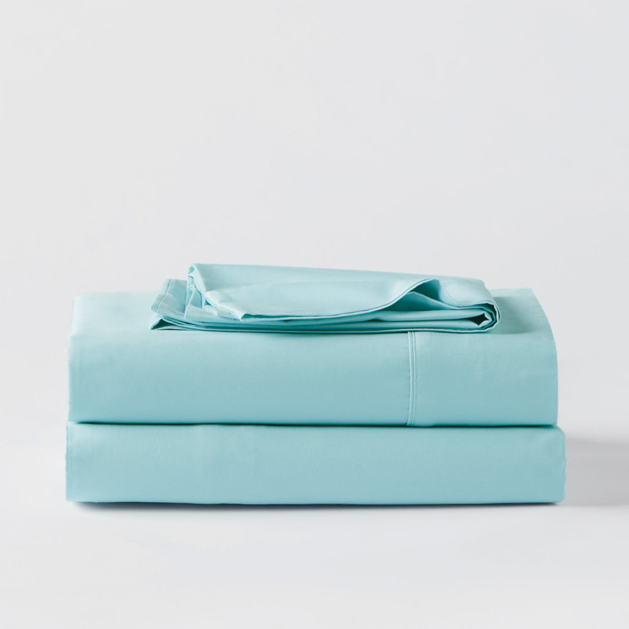 Premium Percale Eggshell Blue Sheets folded up on floor