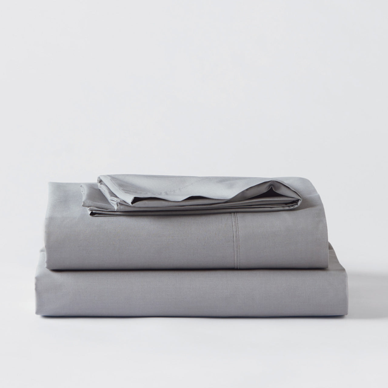 Premium Percale Pewter Sheets folded up on floor