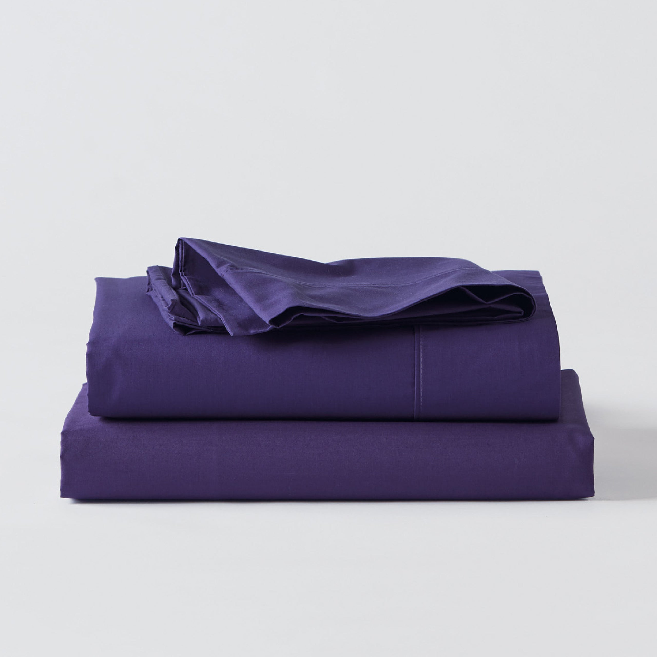 Premium Percale Purple Sheets folded up on floor