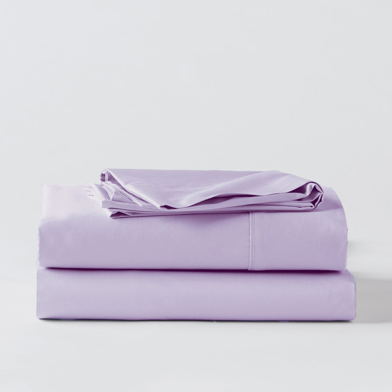 Premium Percale Violet Sheets folded up on floor