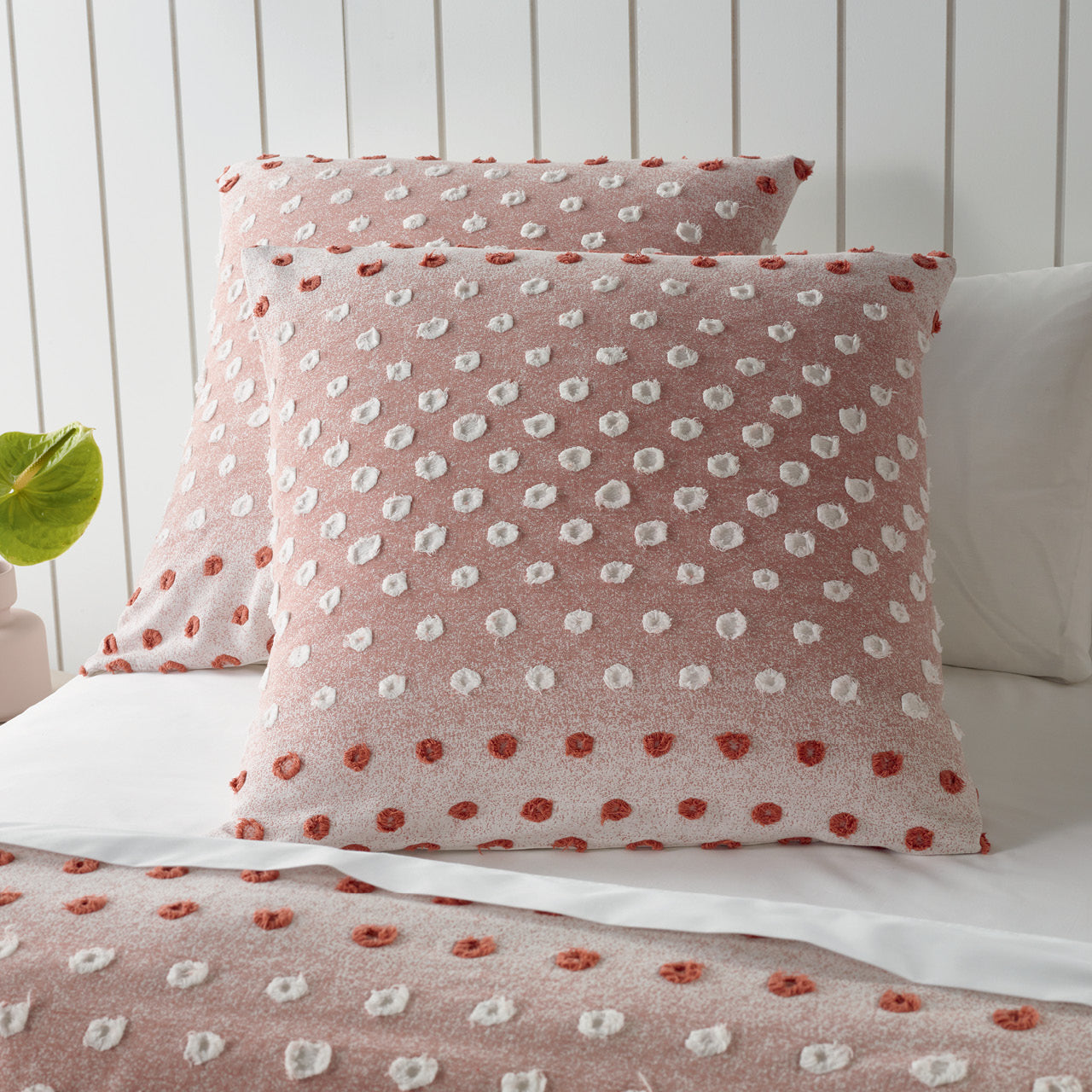 Zoomed in shot of Ruby European Pillowcases on bed