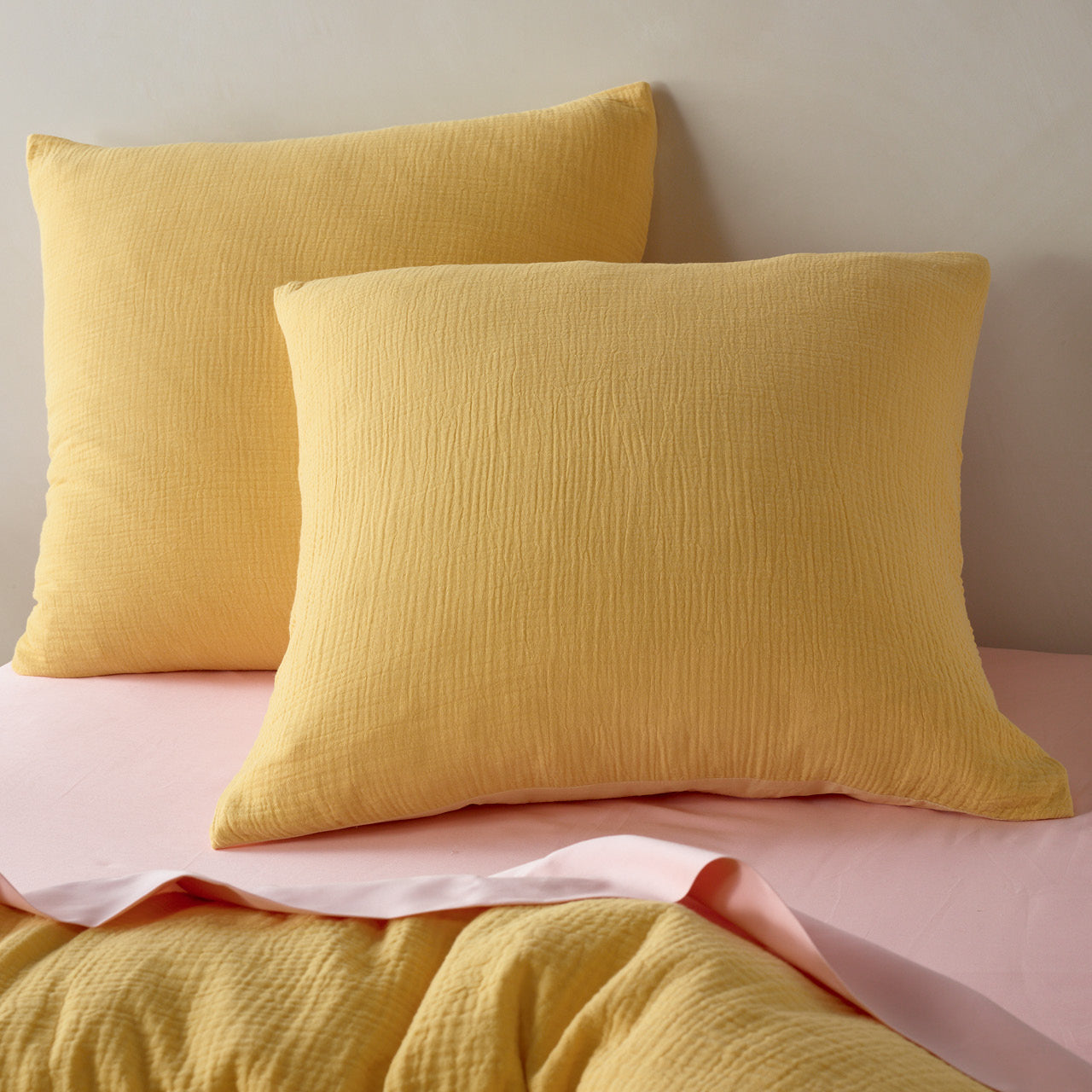 Zoomed in shot of Saffron European Pillowcases on bed
