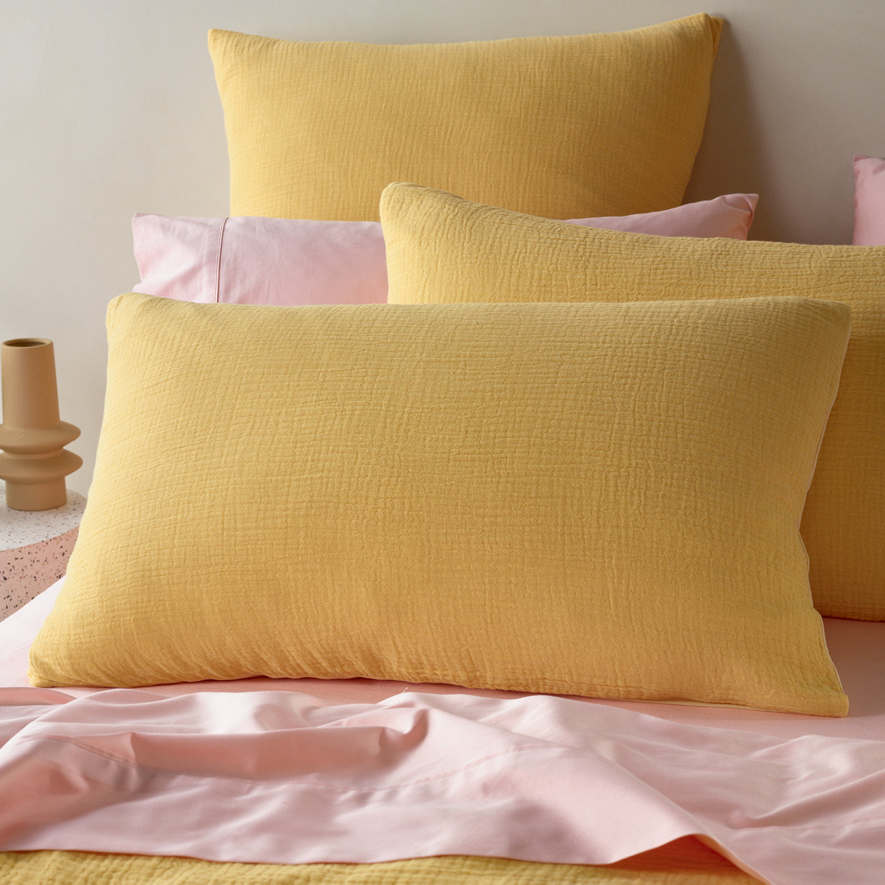 Close up shot of Saffron Pillowcases on bed