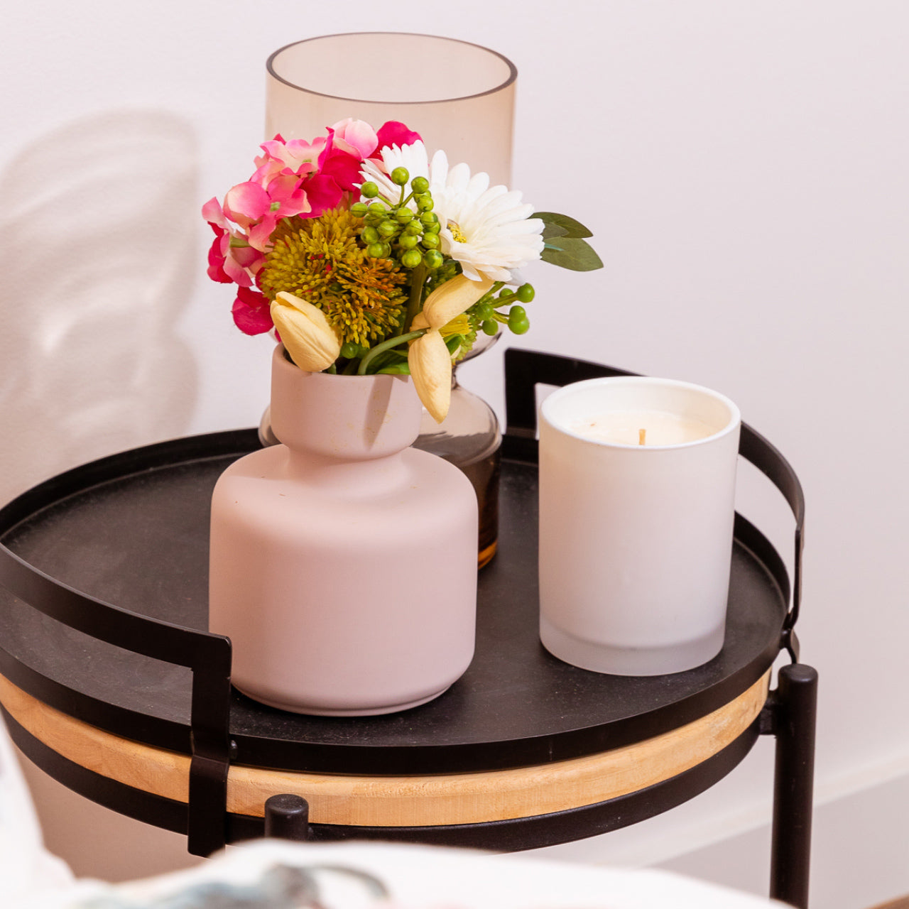 Lifestyle shot of Serra Vase Pink on bedside table with flowers