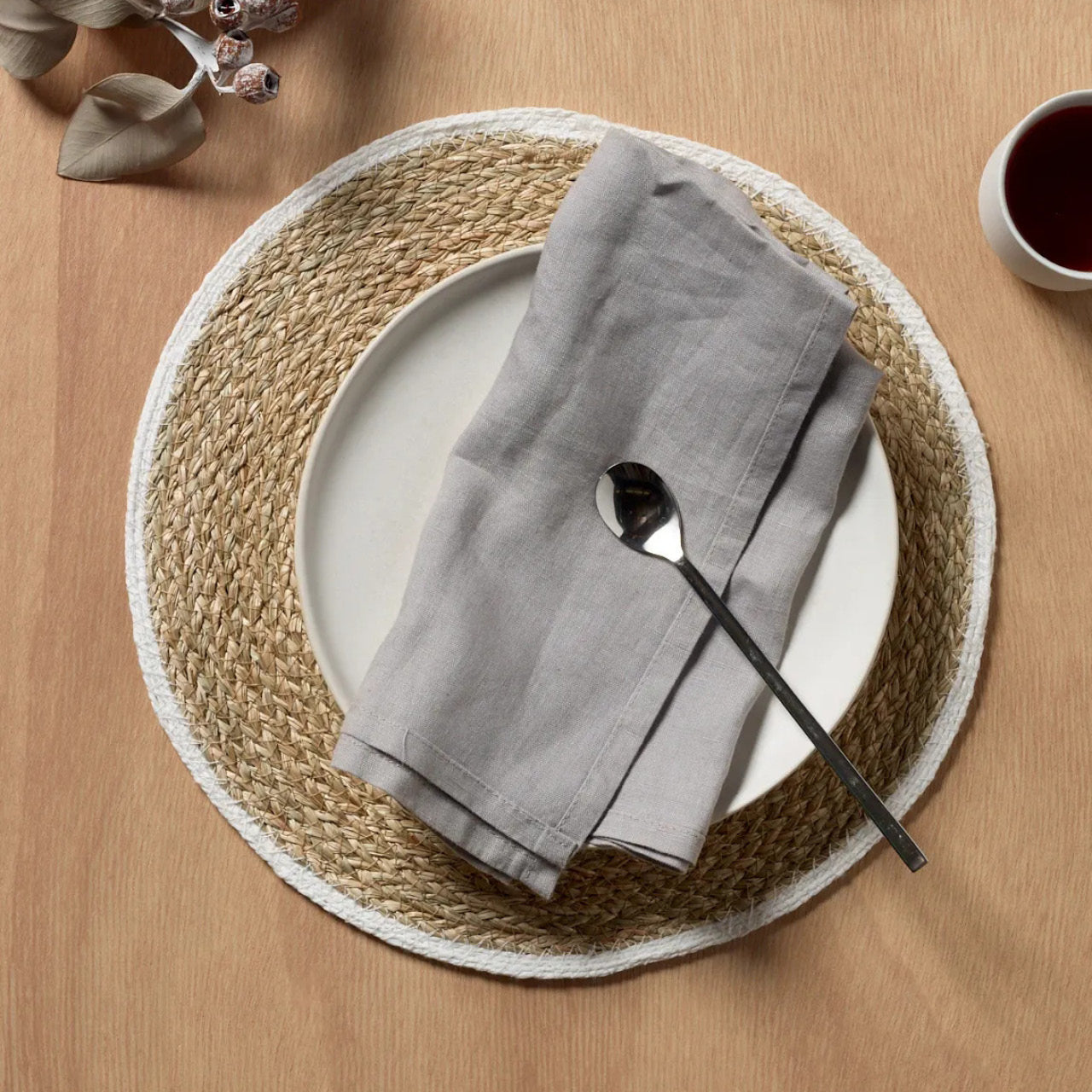 Lifestyle shot of Shelly Placemat on table with plate, napkin and spoon