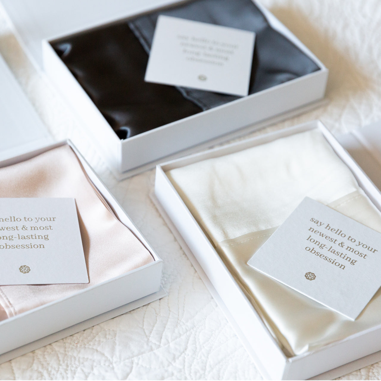 Group shot of all Silk Royale Pillowcases in boxes with cards
