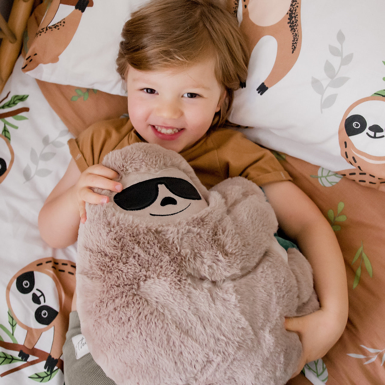 Lifestyle shot of child playing with the Sloth Soft Toy