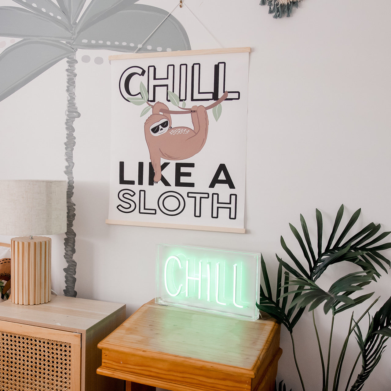Lifestyle shot of Sloth Neon Light sitting on bedside table