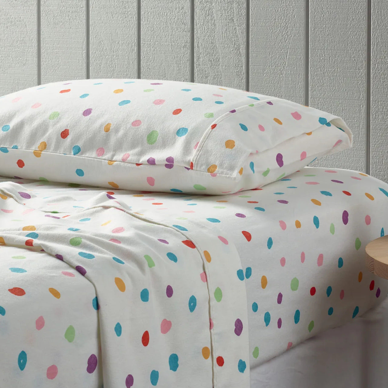 Side view of Spots Flannelette Sheets on bed