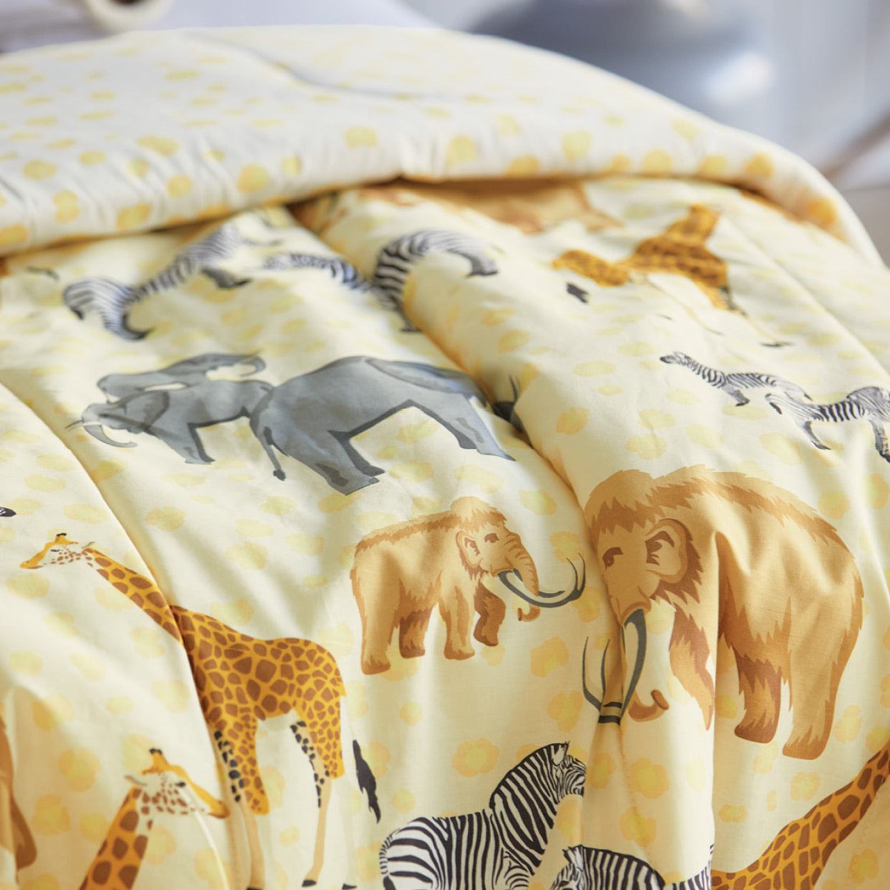 Close up shot of Taronga Comforter on bed