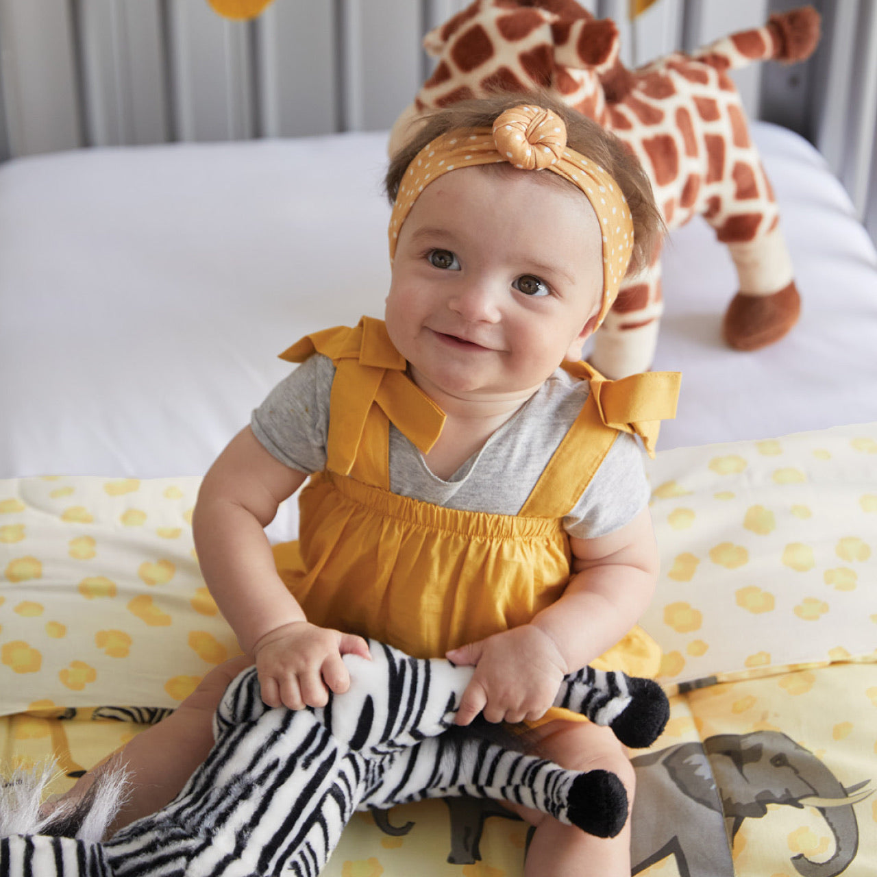 Lifestyle shot of baby in cot with Taronga Cot Comforter