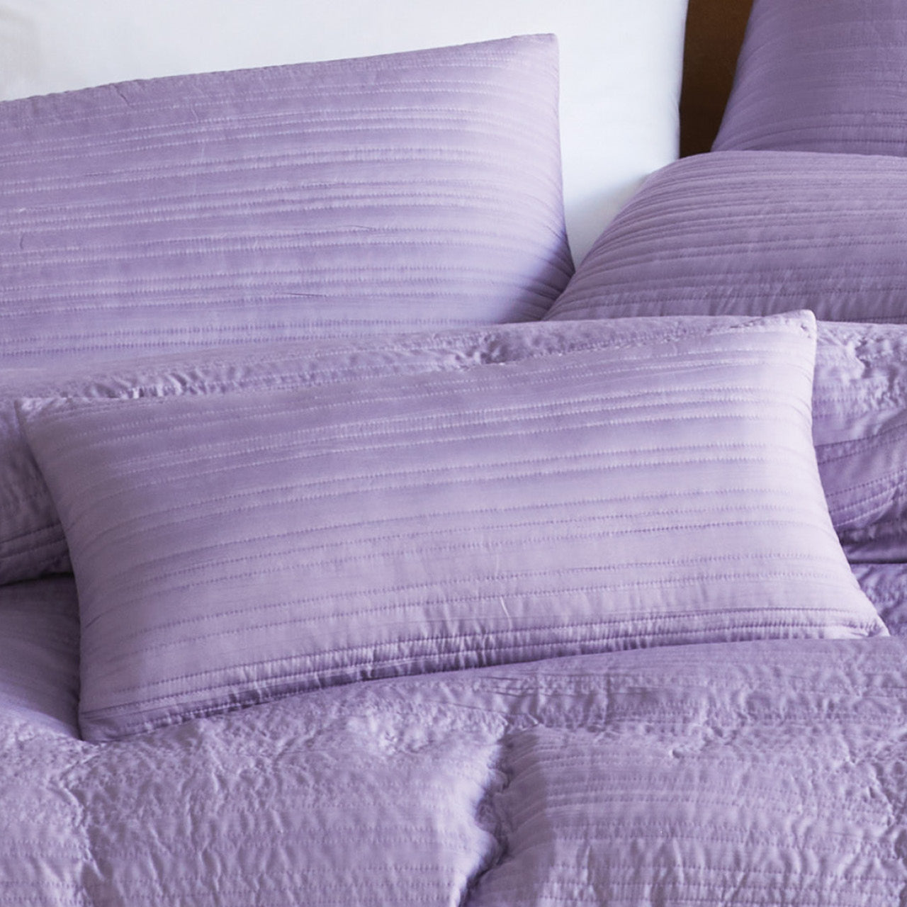 Close up shot of Taya Dusk Pillowcases on bed