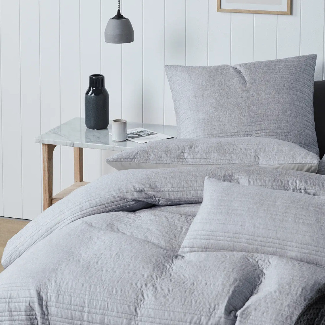 Close up shot of Taya Grey Marle Cushion Covers on bed