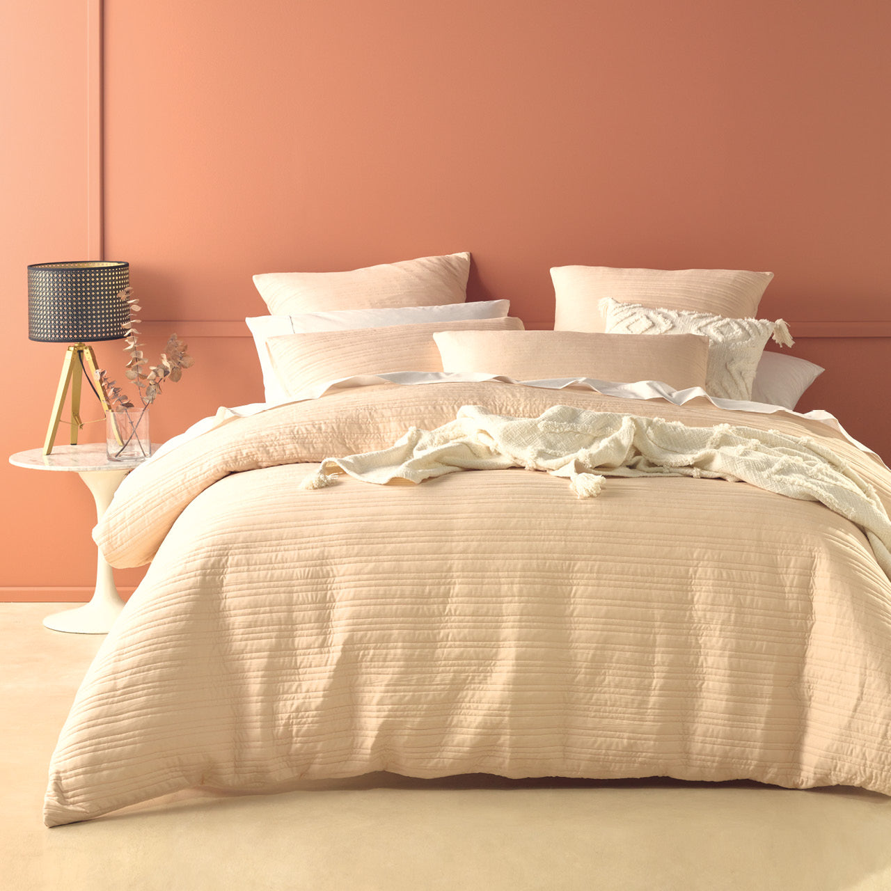 Zoomed out shot of Taya Natural Quilt Cover Set on bed
