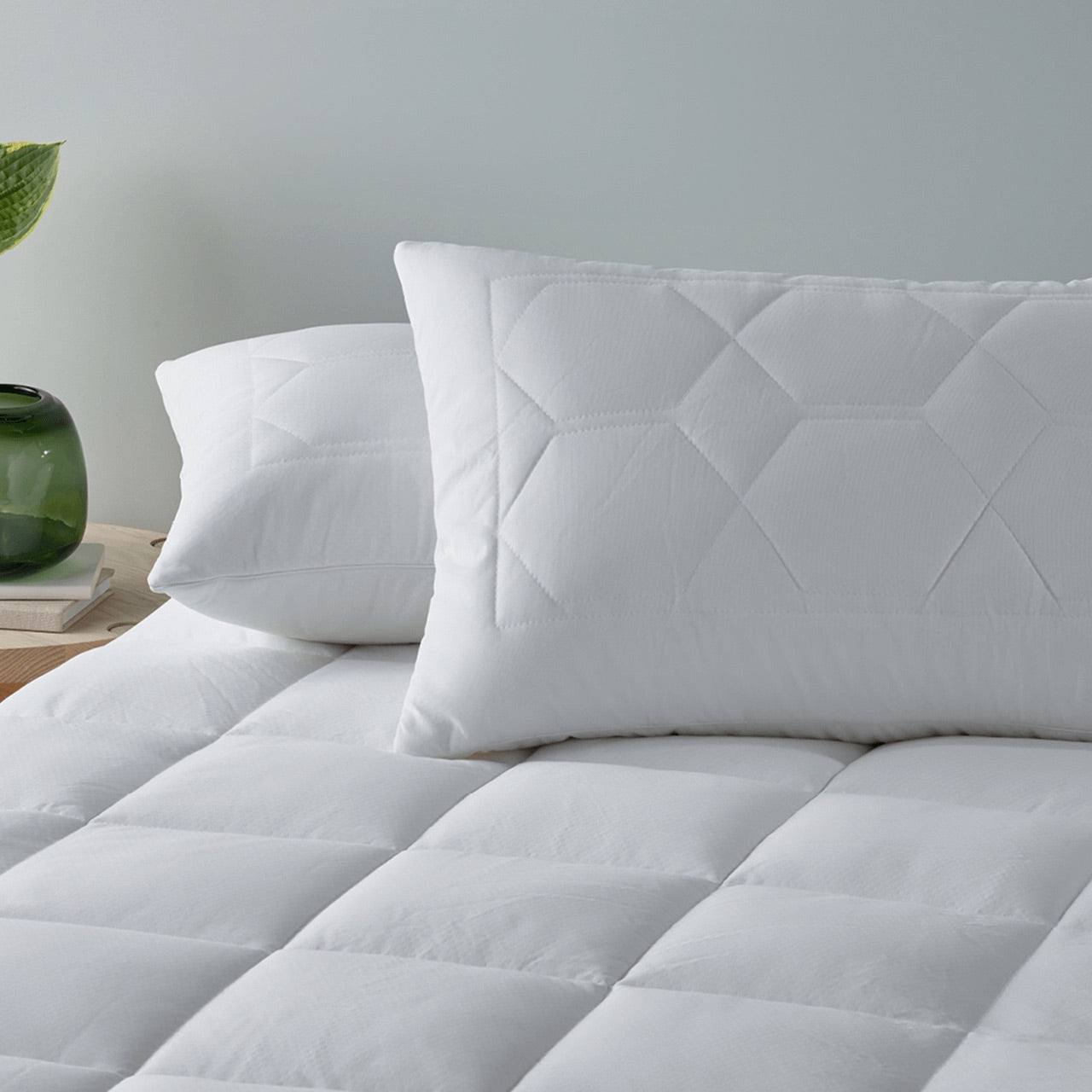 Thermal Balancing Pillow Protectors on pillows on a bed with Thermal Balancing Mattress Protector