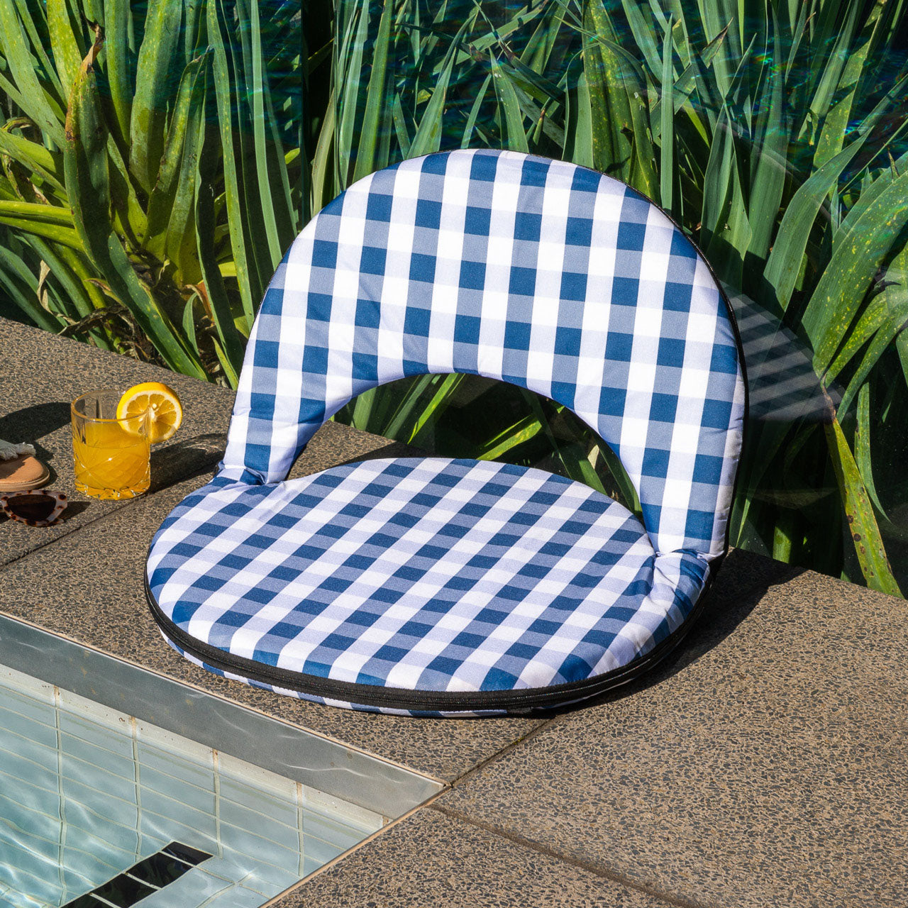 Lifestyle shot of Trinity Beach Chair next to pool with drink