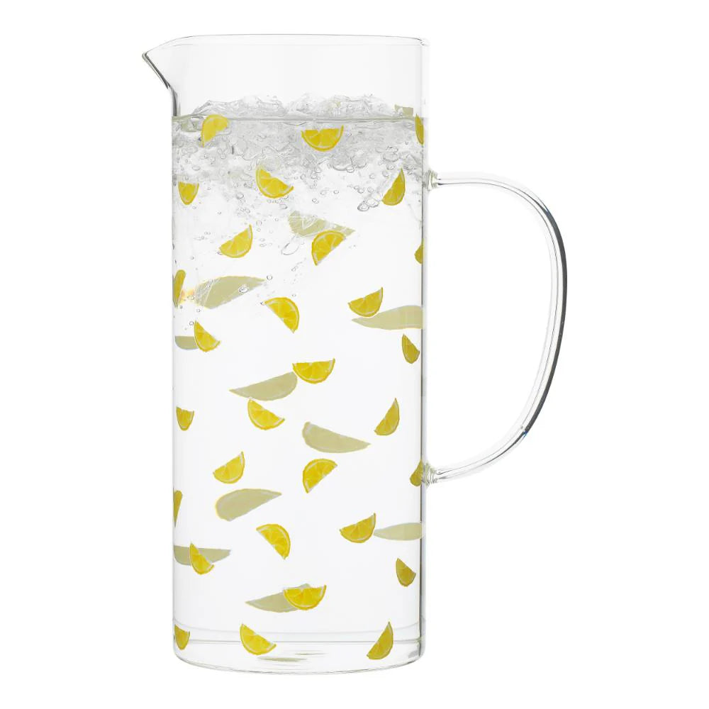 Clear glass pitcher with lemon pattern on a white background