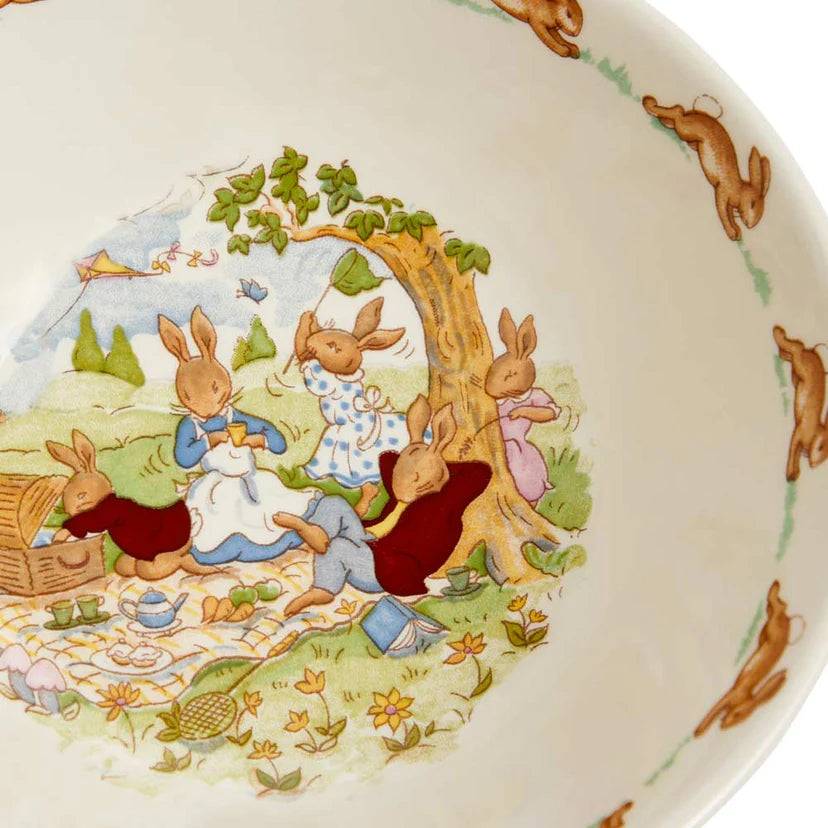 Decorative plate with rabbit illustrations and a picnic scene