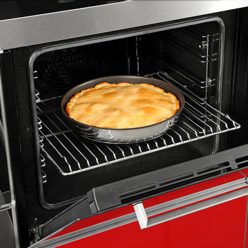 Pie baking in an oven with a red exterior