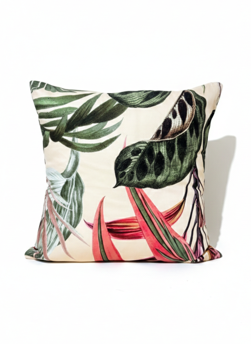 Decorative pillow with tropical leaf pattern on a white background