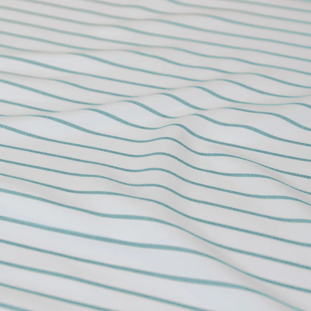 Close-up of fabric with wavy blue stripes on a white background