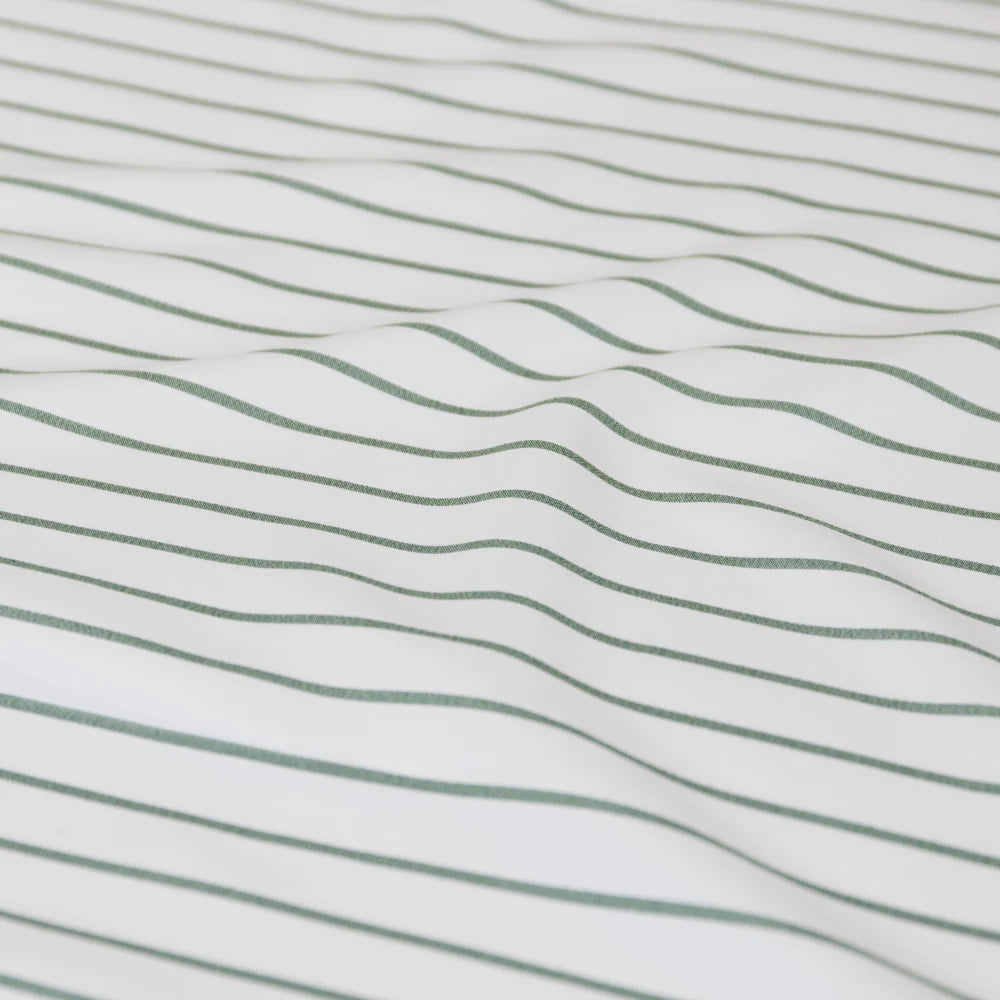 Close-up of fabric with wavy green lines on a white background