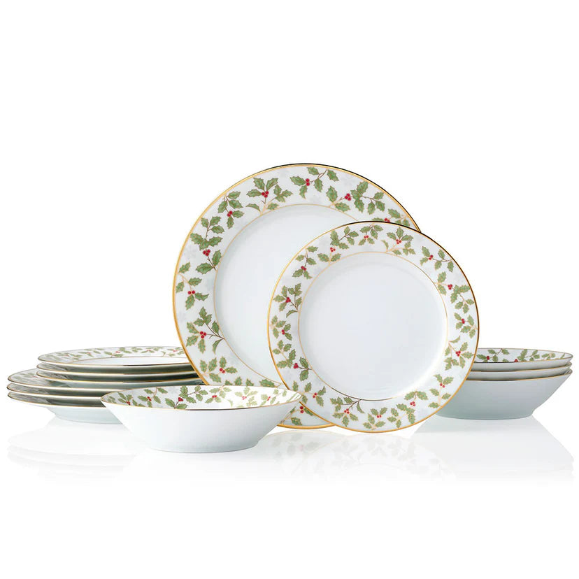 Set of white dinner plates with holly berry design on a white background