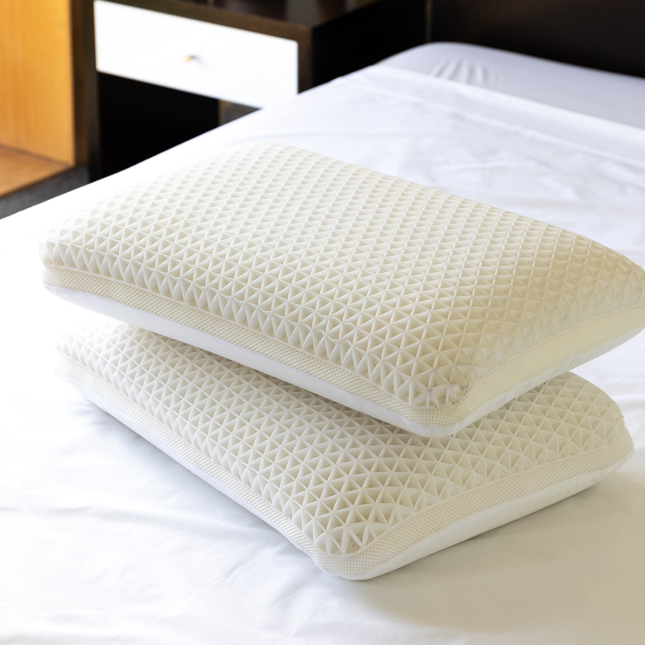 Group shot of Cool Touch Pillows stacked on bed