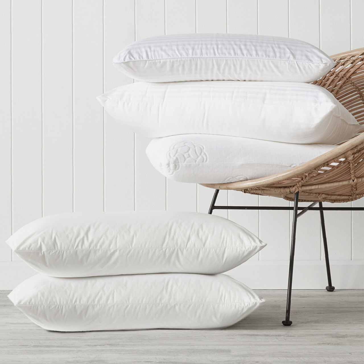 Group shot of various pillows on a chair and on the floor